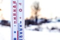Thermometer shows 20 degrees of frost. Thermometer in the background of the winter landscape. Weather forecast. Very cold_ Royalty Free Stock Photo