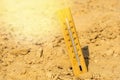 Thermometer shows very hot summer temperature in dry desert sand dunes Royalty Free Stock Photo