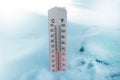 Thermometer on snow shows freezing temperature in celsius or farenheit Royalty Free Stock Photo