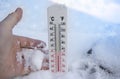 Thermometer on snow shows freezing temperature in celsius or farenheit Royalty Free Stock Photo