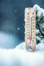 Thermometer on snow shows low temperatures in celsius or farenheit Royalty Free Stock Photo