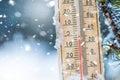 Thermometer on snow shows low temperatures in celsius or farenheit