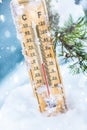 Thermometer on snow shows low temperatures in celsius or farenheit Royalty Free Stock Photo