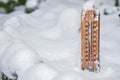 Thermometer on snow shows low temperatures under zero. Low temperatures in degrees Celsius and Fahrenheit. Christmas, freeze