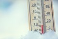 Thermometer on snow shows low temperatures under zero. Low tempe Royalty Free Stock Photo