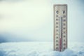 Thermometer on snow shows low temperatures under zero. Low tempe Royalty Free Stock Photo