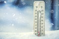 Thermometer on snow shows low temperatures under zero. Low temperatures in degrees Celsius and fahrenheit. Royalty Free Stock Photo