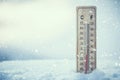 Thermometer on snow shows low temperatures under zero. Low tempe Royalty Free Stock Photo