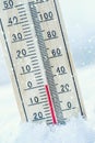 Thermometer on snow shows low temperatures zero. Low temperature Royalty Free Stock Photo