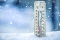 Thermometer on snow shows low temperatures - zero. Low temperatures in degrees Celsius and fahrenheit. Cold winter weather - zero