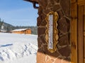 Thermometer on a stone wall. Winter sunny day at the ski resort