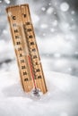Thermometer with subzero temperature stuck in the snow in the winter