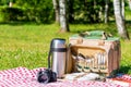 A thermos bottle with utensils, a thermos with tea and a camera Royalty Free Stock Photo