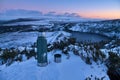 Thermos and a cup of tea at the snowy summit and scenic evening view over Lough Bray Upper lake seen from Eagles Crag