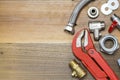 Thermostatic valve and plumber tools on wooden background