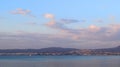 Thessaloniki city as seen from Peraia. Sunset over blue sea. Royalty Free Stock Photo