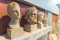 07.13.2022 Thessaloniki, Greece. Ancient heads of Greek statues placed on a shelf display in the Archaeological Museum