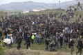 Hundreds of migrants and refugees gathered outside of a refugee camp in Diavata Royalty Free Stock Photo