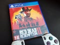 Thessaloniki, Greece, February 11, 2020: The New Red Dead Redemption 2 game with ps4 v2 white Joystick on black