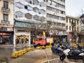 Thessaloniki, Greece Fire brigade servicemen with yellow protective coats cutting tree branches in the city center