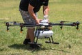 Professional agriculture drone on the green field during pre-fli