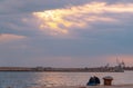 Girls are  seating in the road by the sea they enjoy the good weather and the sunset Royalty Free Stock Photo