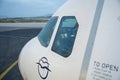 THESSALONIKI, GREECE - OCTOBER 15, 2016: An airplane at the boarding gate of airport, jetway and cockpit with pilot