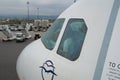 THESSALONIKI, GREECE - OCTOBER 15, 2016: An airplane at the boarding gate of airport, jetway and cockpit with pilot