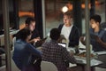 Theyre the dream team. Shot of employees working in an office at night.