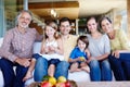 Theyre happiest when theyre all together. A portrait of a happy multi-generational family gathered at home in their Royalty Free Stock Photo