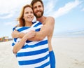 Theyre so happy together. a young man embracing his girlfriend on the beach. Royalty Free Stock Photo