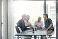 Theyre innovators of business. a group of businessmen having a meeting around a table in an office. Royalty Free Stock Photo