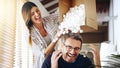 Theyre just being silly. a mature couple having fun with foam packaging balls while moving house.