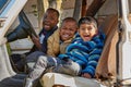 Theyre just being silly. Portrait of a group of little boys having fun while sitting in a car.