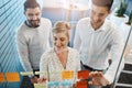 Theyre making progress. three young businesspeople brainstorming with sticky notes on a glass wall in the office. Royalty Free Stock Photo