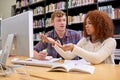 Theyre preparing to ace their mid-terms. two students working together at a computer in a university library. Royalty Free Stock Photo