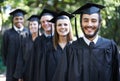 They're proud graduates. Portrait of a group of happy students on graduation day. Royalty Free Stock Photo