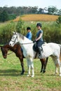 Theyre ready for some serious horse riding. Portrait of two young women on horseback outside. Royalty Free Stock Photo