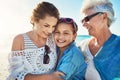 Theyre three of a kind. a senior woman spending the day at the beach with her daughter and granddaughter.