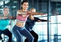 Theyre in it to win it. three attractive young women working out together in the gym. Royalty Free Stock Photo