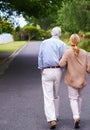 Theyre in it together. Rearview of an elderly couple taking a walk.