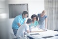 Theyve got a great design. A group of architects discussing a building model during a meeting.