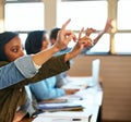 Theyve got questions. a group of university students sitting with their hands raised in class. Royalty Free Stock Photo