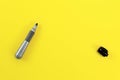 Thick black marker pen with opened cap on yellow board - space to write your text, view from above Royalty Free Stock Photo