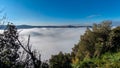 A thick blanket of fog has covered the crater of Lake Albano in