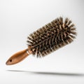 A thick boar bristle round brush, floating in mid air on a solid white background Royalty Free Stock Photo