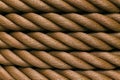 Thick brown rope rolled into a roll. Horizontal layout.