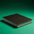A thick, closed book with a black cover rests on a green surface. The cover features a Royalty Free Stock Photo