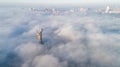 Thick clouds of autumn fog and the Motherland monument sticking out of them Royalty Free Stock Photo