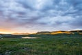 Thick Clouds Catch The Sunset Colors Over Hayden Valley and The Yellowstone River Royalty Free Stock Photo